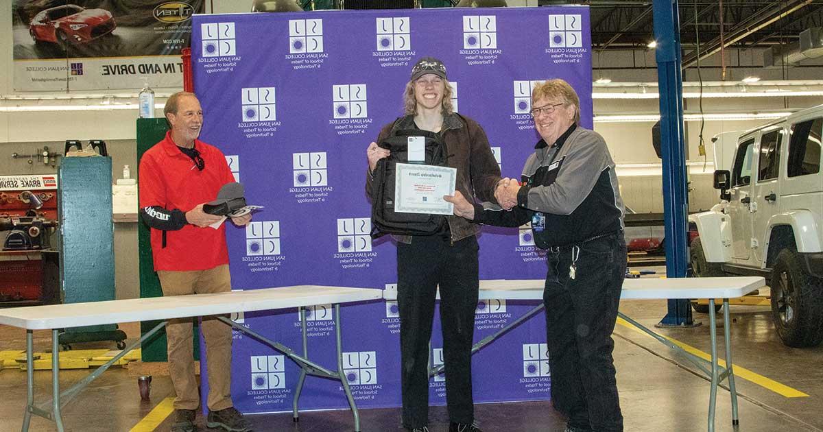 Student receiving an award and shaking hands